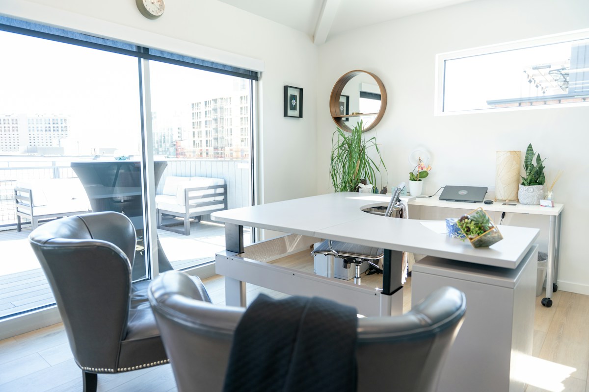 A bright modern office with organized workspaces and large windows